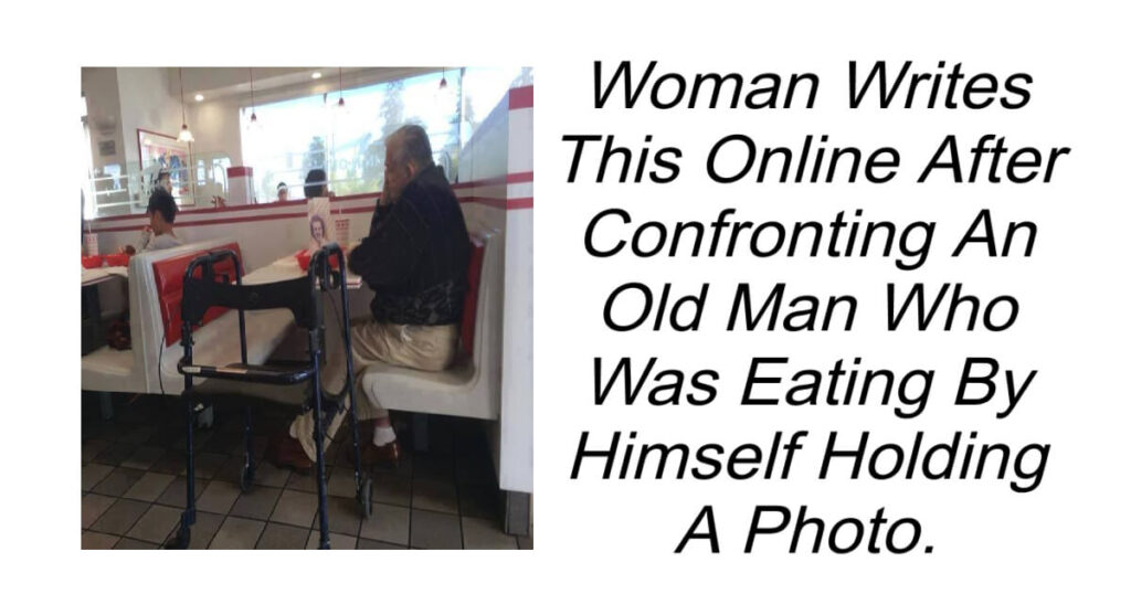 An Old Man Was Eating Alone Holding a Photo.